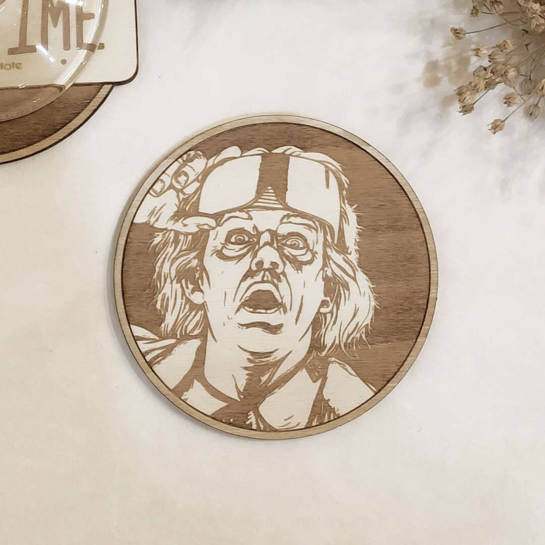 Close-up of detailed laser-etched Back to The Future designs on wooden coasters