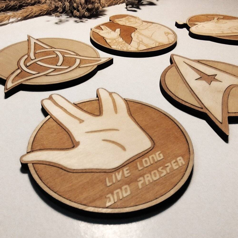 Six durable wooden coasters featuring iconic Star Trek motifs, designed for fans who live long and prosper